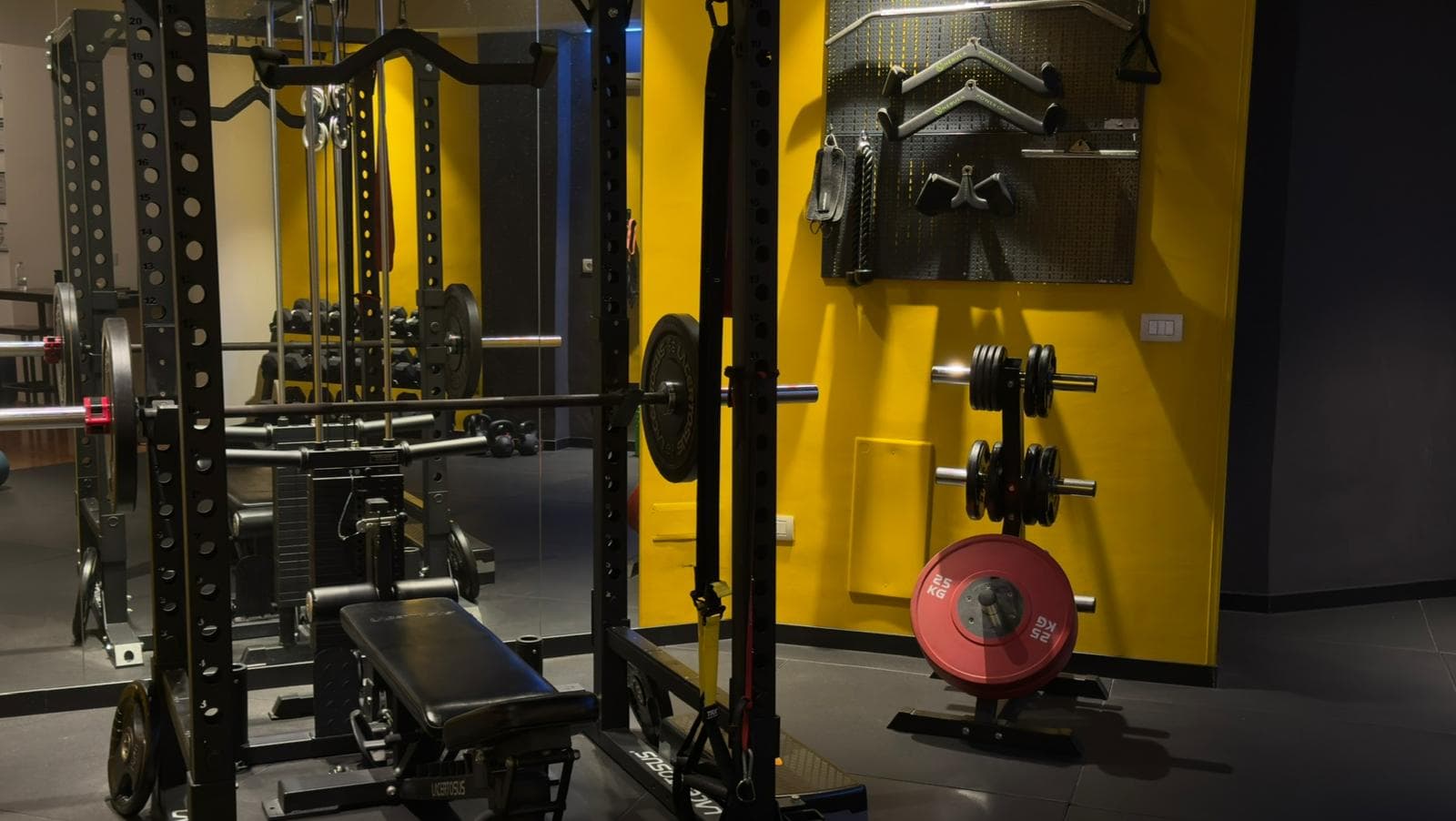 Man lifting heavy weights in dark gym